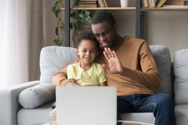 istock Happy african father and kid son making video call 1135353566