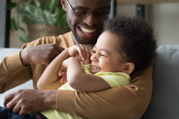 istock Affectionate loving african dad holding tickling child toddler son 1135353585