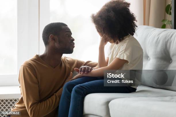 Loving African Dad Comforting Crying Kid Daughter Showing Empathy Stock Photo - Download Image Now