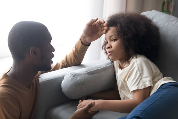 istock Caring african father touching forehead of ill kid daughter 1135353633