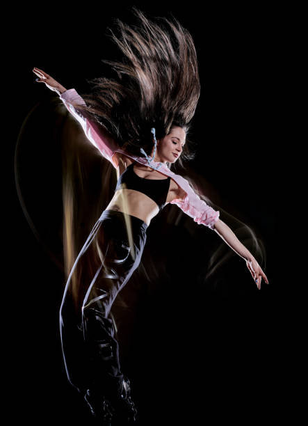 istock young woman modern dancer dancing isolated black background light painting 1135353778