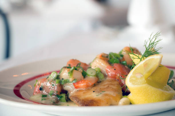A Profile Shot Of Popular Seafood Dish From New Orleans Garnished With Lemon and Dill