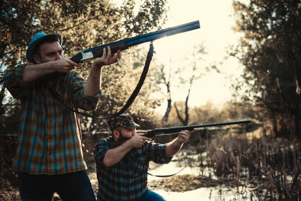 istock Two Hunters Aiming At Prey In Sunset 1135356724