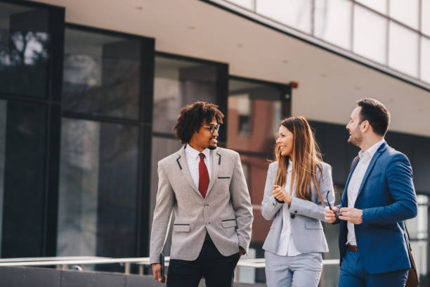 istock Three business colleagues walking outdoors and discussing. 1135356789