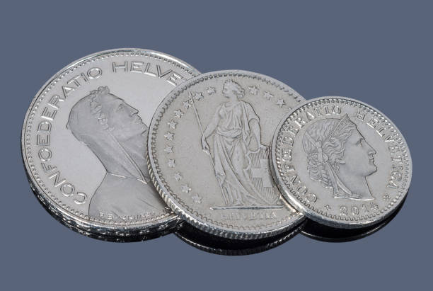 istock Switzerland coins on a gray mirror background 1135356806