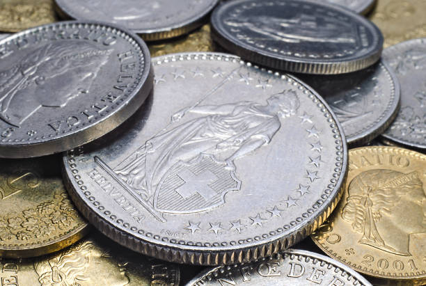 istock Heap of sniny Swiss coins closeup background 1135356830