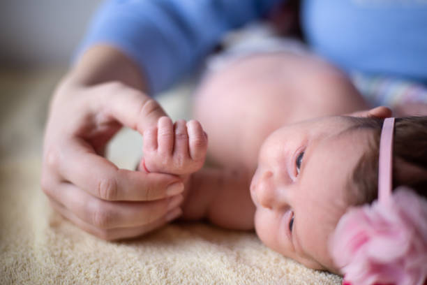 istock Newborn baby holding mother's hand 1135356869