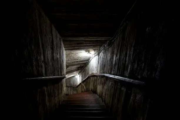 Photo of Stairs going into a dark tunnel