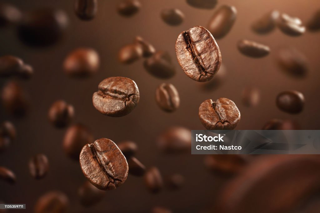 Roasted coffee beans falling down Roasted coffee beans falling down with copy space Coffee - Drink Stock Photo