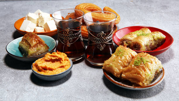 istock Middle eastern or arabic dishes and assorted meze, concrete rustic background. sambusak. Turkish Dessert Baklava with pistachio. Halal food. 1135360126