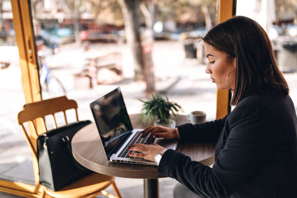 istock Beauty woman using laptop in cafe bar 1135361695