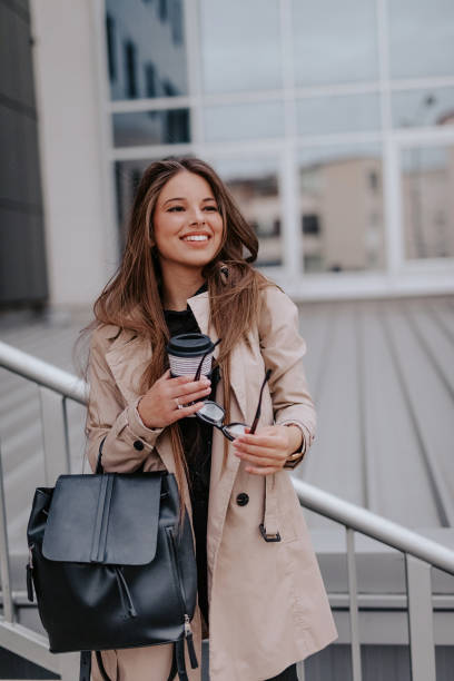 istock Business woman smiling and holding coffee 1135362071