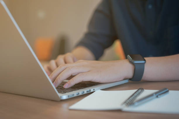 close up young journalist man hand typing keyboard laptop for working and update on website at office, copywriter millennial lifestyle concept