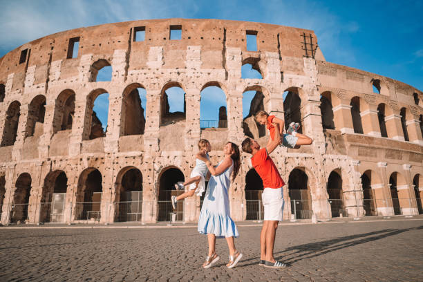 istock Happy family in Rome over Coliseum background. 1135364192