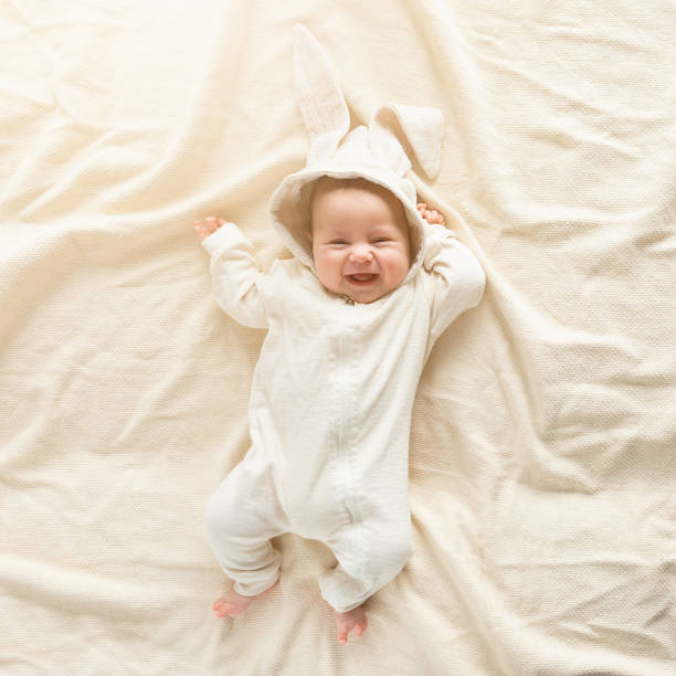 istock Having fun on Easter day. Baby boy wearing bunny costume with ears smiling. 1135364598