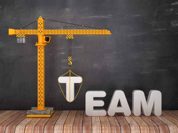 istock Tower Crane with TEAM Word on Chalkboard Background - 3D Rendering 1135365556