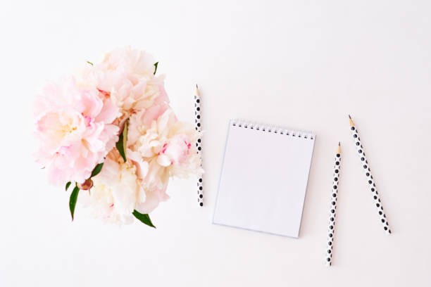 istock Mockup white notebook with pink peonies on a white background 1135366926