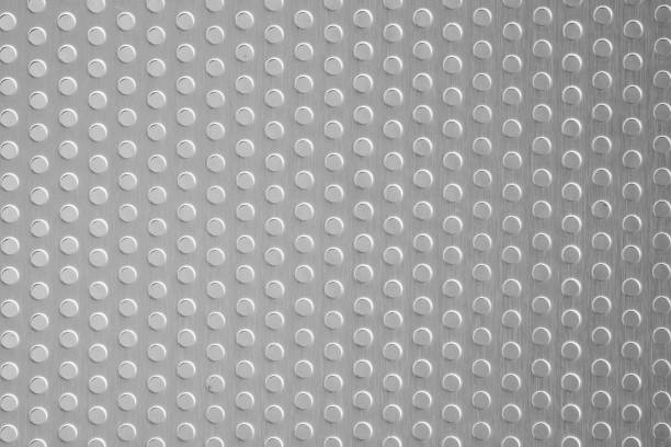 istock Polished stainless steel plate with a porous circle texture background 1135367132