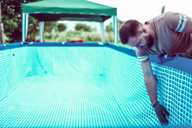 istock Handsome Male Setting Up Swimming Pool In Backyard 1135368024