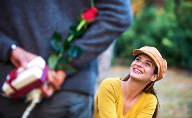 istock Dating. Young man surprised his girlfriend with a present. Love and relationships 1135368062