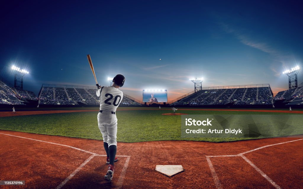 Baseball Baseball player at professional baseball stadium in evening during a game. Baseball - Sport Stock Photo