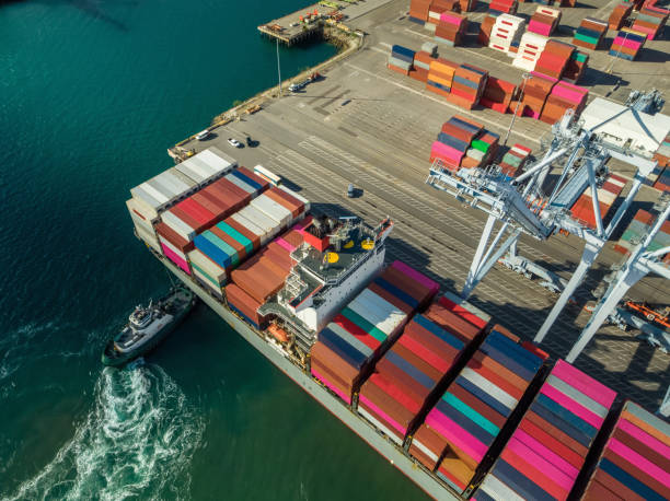 istock Ship Arriving at Dockside Container Terminal - Aerial 1135372734