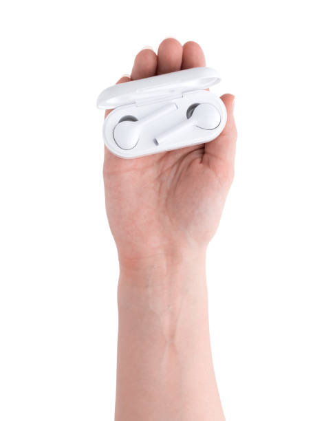 istock Wireless headphones in hand on a white background. Wireless headset with charging case in hand. 1135374189