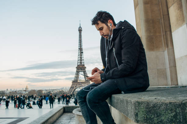 istock Tourist man texting on mobile phone 1135374558
