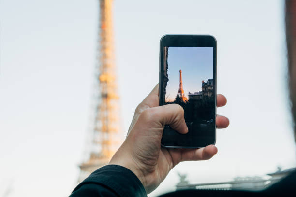 istock Man in front of Eiffel Tower making photograph 1135374863