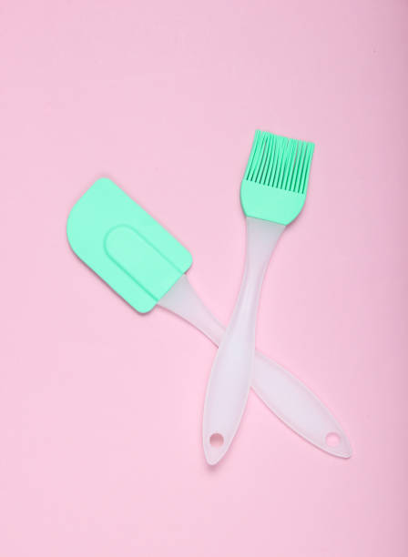 istock Kitchen pastry silicone set (spatula and brush) on pink  pastel background. Top view, minimalism 1135375157