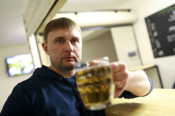 istock Man holding mug of lager beer 1135375943
