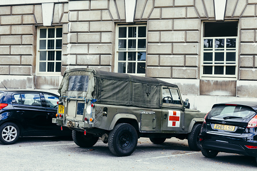 London, UK - February 05, 2023: Land Rover Defender parked in London on Sunday morning as the famous 10k charity run closed the streets of London. More than thousand people took part in the Cancer Research Charity run this year.