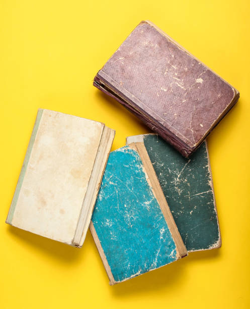 istock Many old book with shabby cover on a yellow background 1135377502