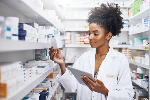 My tablet helps me with safe and accurate stock management Cropped shot of a pharmacist using a digital tablet in a chemist counting photos stock pictures, royalty-free photos & images