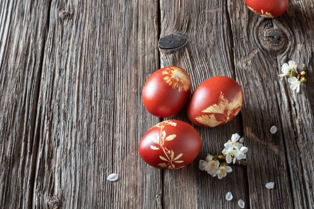 istock Easter eggs dyed with onion peels with a pattern of fresh herbs 1135378403