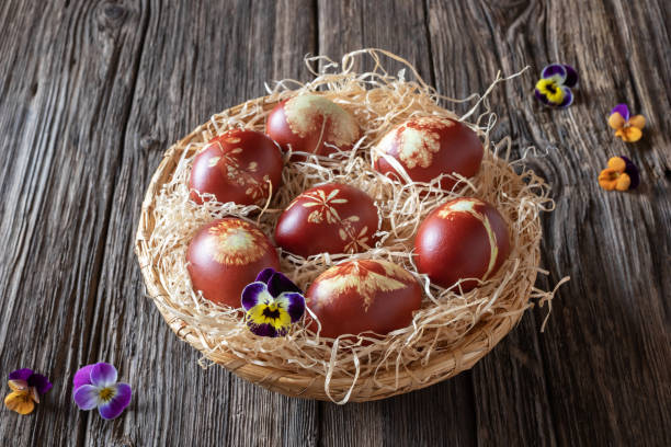 istock Easter eggs dyed with onion peels with a pattern of fresh herbs 1135378417
