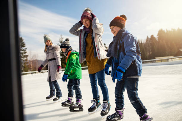 istock Family enjoying ice-skating together 1135378437