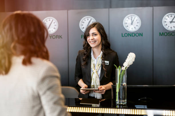 istock Hotel receptionist welcoming guest 1135379755