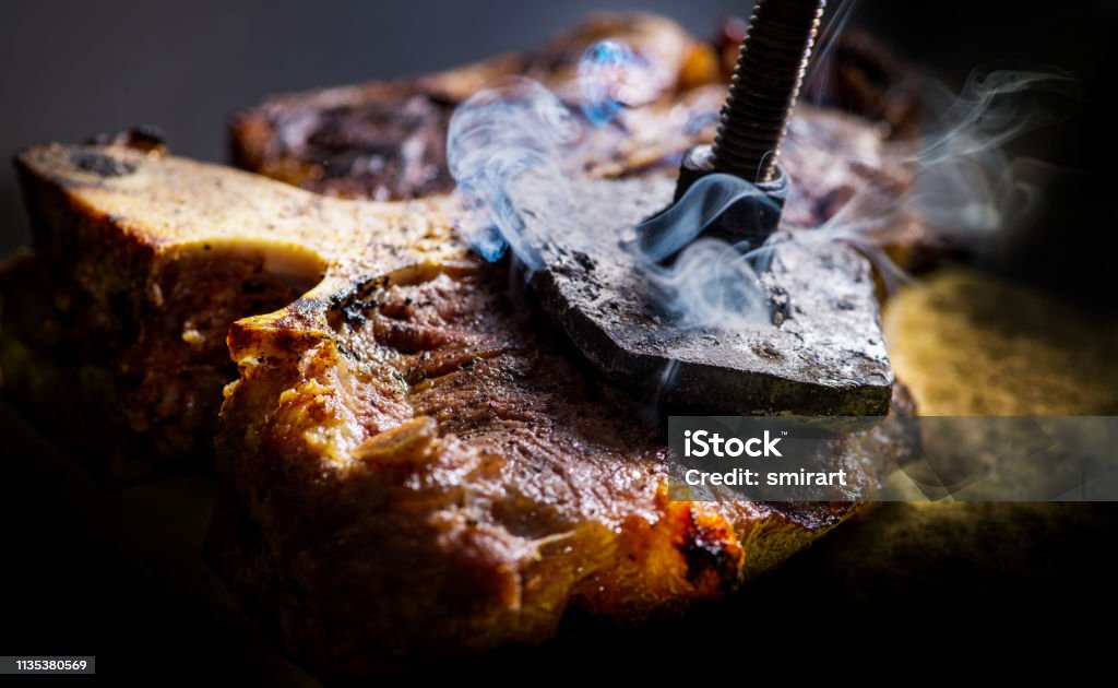 Ready T-bone
Â  steak on which burns the stigma of the logo Backgrounds Stock Photo