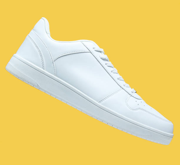 One White sneaker and isolated on yellow background