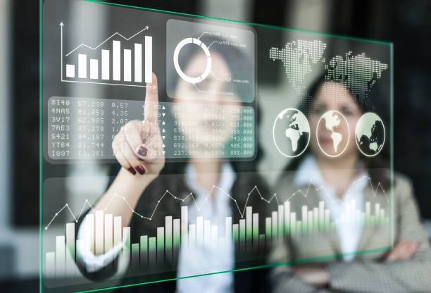 istock Businesswomen discussing financial dashboard on Projection Screen 1135380732