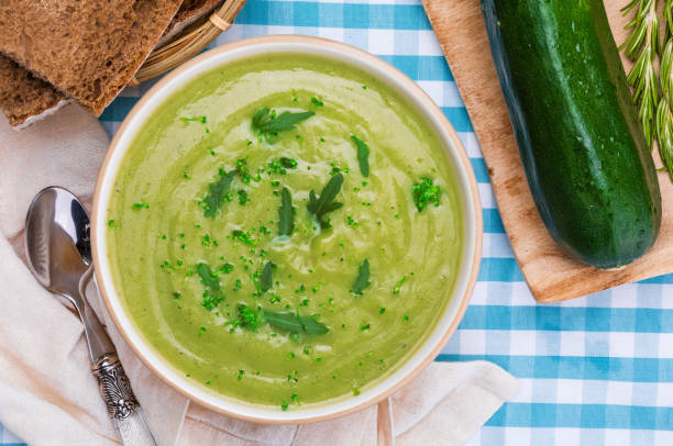 istock Delicious zucchini cream. Home and rustic appearance. Includes fresh zucchini, rosemary and rye bread. Top view. 1135380936