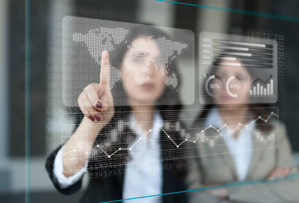 istock Businesswomen discussing financial dashboard on Projection Screen 1135381222