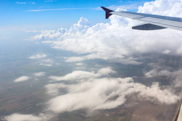 View of the earth from the airplane window. The view from the window of the plane to the ground and clouds. earth's atmosphere stock pictures, royalty-free photos & images