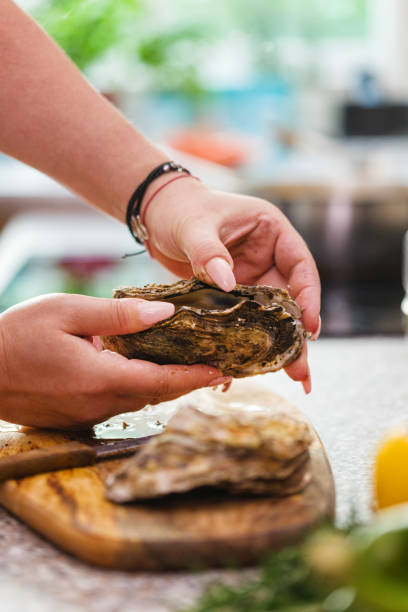 istock Young Women Preparing Fresh Oysters 1135384089