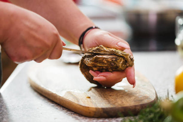 istock Young Women Preparing Fresh Oysters 1135384119
