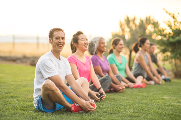 istock Group doing a co-ed fitness class outside in the morning 1135385101