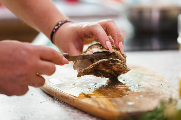 Young Women Preparing Fresh Oysters
