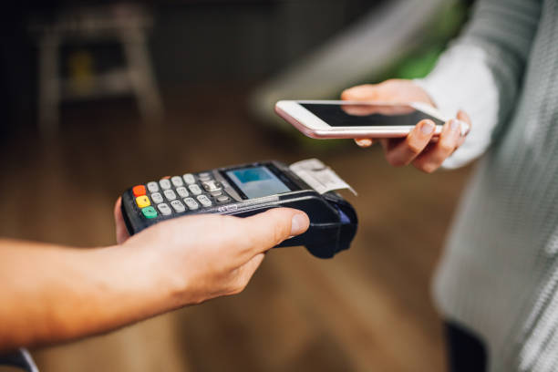 istock Contactless payment using a smart phone hand close up 1135385345