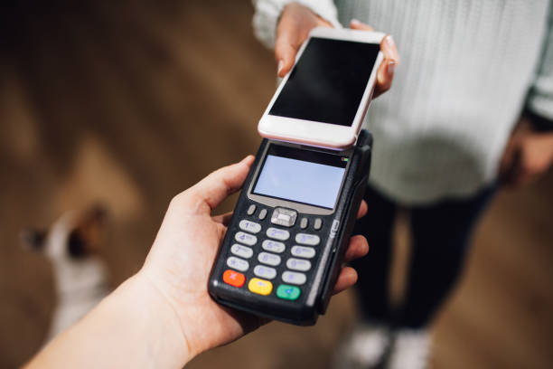 istock Contactless payment using a smart phone hand close up 1135385349